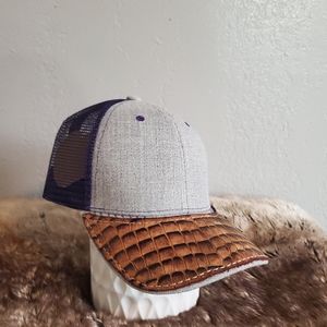 Ball cap with hand-sewn leather patch on brim